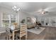 Bright living room with hardwood floors, neutral paint, and dining area by large windows at 124 Birch N Coppice Dr. # 1, Surfside Beach, SC 29575