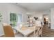Well-lit dining room with sliding glass doors to the backyard and an open view of the living room at 1402 Nokota Dr., Conway, SC 29526