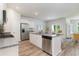 Bright kitchen featuring a granite island with a stainless steel dishwasher and view to the dining area at 1402 Nokota Dr., Conway, SC 29526