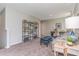 Cozy living room featuring two bookshelves, a desk, and a comfortable striped couch at 1442 Nokota Dr., Conway, SC 29526