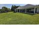 Expansive backyard with lush lawn, covered patios, and panoramic lake views at 1455 Whooping Crane Dr., Conway, SC 29526