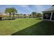 Spacious backyard with lush lawn, black metal fencing, and picturesque lake views at 1455 Whooping Crane Dr., Conway, SC 29526