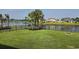 Large backyard with lush lawn, black metal fencing, and beautiful lake views at 1455 Whooping Crane Dr., Conway, SC 29526