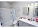 Bright bathroom featuring a shower-tub combo and a double sink vanity with modern fixtures at 1455 Whooping Crane Dr., Conway, SC 29526