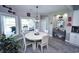 Cozy dining area with a round table, stylish decor, and a view of the outdoor grill at 1455 Whooping Crane Dr., Conway, SC 29526