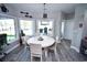 Charming dining room featuring a round table, wainscoting, large windows, and scenic backyard views at 1455 Whooping Crane Dr., Conway, SC 29526