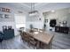 Stylish dining room with a large wooden table, modern lighting, and decorative wall art at 1455 Whooping Crane Dr., Conway, SC 29526
