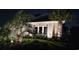 Charming home exterior at night featuring lush landscaping and inviting lighting at 1455 Whooping Crane Dr., Conway, SC 29526
