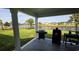 Covered patio with outdoor grill overlooking a fenced backyard with a lake view at 1455 Whooping Crane Dr., Conway, SC 29526