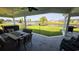 Covered patio with outdoor dining set overlooking a fenced backyard with lake views at 1455 Whooping Crane Dr., Conway, SC 29526