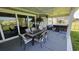 Outdoor patio with dining set, hot tub, and scenic lake view in the backyard at 1455 Whooping Crane Dr., Conway, SC 29526