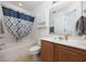 Bathroom with tub and shower, vanity, and cabinet space for storage at 155 Chenoa Dr. # D, Murrells Inlet, SC 29576