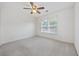 Well-lit bedroom featuring a ceiling fan and a window, perfect for relaxation and comfort at 155 Chenoa Dr. # D, Murrells Inlet, SC 29576