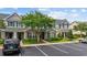 Charming townhome featuring brick accents, green shutters, well-maintained landscaping, and dedicated parking at 155 Chenoa Dr. # D, Murrells Inlet, SC 29576