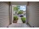 Welcoming exterior view through a covered entryway, offering a glimpse of the community at 155 Chenoa Dr. # D, Murrells Inlet, SC 29576