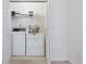 Well-lit laundry room with washer, dryer, and shelving for storage at 155 Chenoa Dr. # D, Murrells Inlet, SC 29576