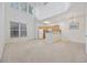 Spacious living area with high ceilings, an adjacent kitchen, and natural light from large windows at 155 Chenoa Dr. # D, Murrells Inlet, SC 29576