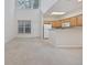 Spacious living area with high ceilings, an adjacent kitchen, and natural light from large windows at 155 Chenoa Dr. # D, Murrells Inlet, SC 29576