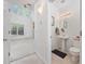 Bright powder room with a pedestal sink and adjacent living area at 155 Chenoa Dr. # D, Murrells Inlet, SC 29576