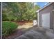 Exterior backyard view features tidy landscaping, mature trees, and convenient storage at 155 Chenoa Dr. # E, Murrells Inlet, SC 29576