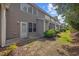 Exterior backyard view features tidy landscaping, grassy area and access door at 155 Chenoa Dr. # E, Murrells Inlet, SC 29576