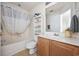 Cozy bathroom featuring a shower with curtain, white toilet, and wooden sink at 155 Chenoa Dr. # E, Murrells Inlet, SC 29576