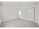 Bright bedroom with neutral carpet, ceiling fan, and double-door closet at 155 Chenoa Dr. # E, Murrells Inlet, SC 29576