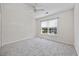 Neutral bedroom with ceiling fan, window with blinds, and soft carpeting at 155 Chenoa Dr. # E, Murrells Inlet, SC 29576
