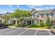 Charming townhome exterior with lush landscaping, green shutters and a well-manicured lawn at 155 Chenoa Dr. # E, Murrells Inlet, SC 29576