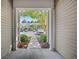 View of well-maintained townhomes from front entrance with decorative bushes and mature tree at 155 Chenoa Dr. # E, Murrells Inlet, SC 29576
