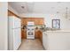 Bright kitchen featuring white appliances, wood cabinetry, and countertop seating at 155 Chenoa Dr. # E, Murrells Inlet, SC 29576