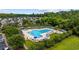 Aerial view of a stunning pool with plenty of lounge chairs, umbrellas, and lush trees at 155 Chenoa Dr. # E, Murrells Inlet, SC 29576