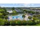 Aerial view of a stunning pool with plenty of lounge chairs, umbrellas, and lush greenery at 155 Chenoa Dr. # E, Murrells Inlet, SC 29576