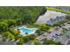 Community pool surrounded by trees, a lake, and residences with a parking lot nearby at 155 Chenoa Dr. # E, Murrells Inlet, SC 29576