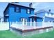 A beautiful deck off the back of a blue house, surrounded by a white picket fence at 1557 Elizabeth Rd., Myrtle Beach, SC 29577