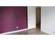 Bedroom with woodgrain floor and dark purple accent wall at 1557 Elizabeth Rd., Myrtle Beach, SC 29577