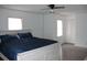 Spacious main bedroom features modern ceiling fan, two windows, and light woodgrain floors at 1557 Elizabeth Rd., Myrtle Beach, SC 29577