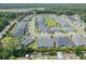 High-angle view showcases homes with manicured lawns nestled in a tranquil community, bordering a scenic waterway at 1584 Sand Harbor Cir. # 1584, Ocean Isle Beach, NC 28469