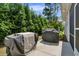 Landscaped backyard featuring two grills and privacy shrubs along the home's edge at 1584 Sand Harbor Cir. # 1584, Ocean Isle Beach, NC 28469