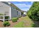 Well-manicured backyard with lush green grass and privacy shrubs near the home at 1584 Sand Harbor Cir. # 1584, Ocean Isle Beach, NC 28469