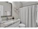 Cozy bathroom with a framed mirror, granite countertop, framed art and shower at 1584 Sand Harbor Cir. # 1584, Ocean Isle Beach, NC 28469