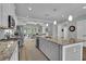 Modern kitchen with a large granite island, stainless steel appliances, and an open layout at 1584 Sand Harbor Cir. # 1584, Ocean Isle Beach, NC 28469