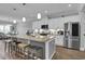 Modern eat-in kitchen with a large island, stainless steel appliances, and pendant lighting at 1584 Sand Harbor Cir. # 1584, Ocean Isle Beach, NC 28469