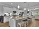 Modern eat-in kitchen with a large island, stainless steel appliances, and pendant lighting at 1584 Sand Harbor Cir. # 1584, Ocean Isle Beach, NC 28469