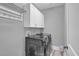 Efficient laundry room with modern washer and dryer, overhead cabinets, and hanging rack at 1584 Sand Harbor Cir. # 1584, Ocean Isle Beach, NC 28469