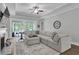 Open-concept living room with a fireplace, tray ceilings, and sliding doors that offer serene outdoor views at 1584 Sand Harbor Cir. # 1584, Ocean Isle Beach, NC 28469