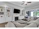 Bright living room boasts a fireplace, custom built-ins, and sliding glass doors to outdoor living space at 1584 Sand Harbor Cir. # 1584, Ocean Isle Beach, NC 28469