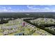 Wide aerial shot showcases the community with lakes and rows of houses surrounded by dense trees at 2131 Cass Lake Dr. # 662, Carolina Shores, NC 28467
