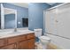 Bathroom featuring blue walls, a vanity with sink, toilet, and glass door shower at 2131 Cass Lake Dr. # 662, Carolina Shores, NC 28467