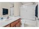 Well-lit bathroom featuring a vanity with storage and a shower-tub combo with glass doors at 2131 Cass Lake Dr. # 662, Carolina Shores, NC 28467